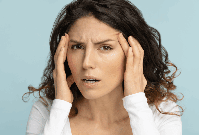 woman looking concerned over the wrinkles on her face